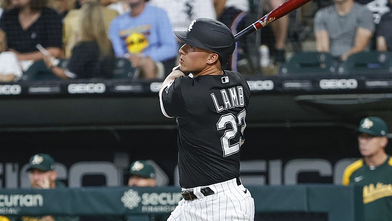 Aug 17, 2021; Chicago, Illinois, USA; Chicago White Sox third baseman Jake Lamb (23) hits a three-run home run against the Oakland Athletics during the second inning at Guaranteed Rate Field. Mandatory Credit: Kamil Krzaczynski-USA TODAY Sports