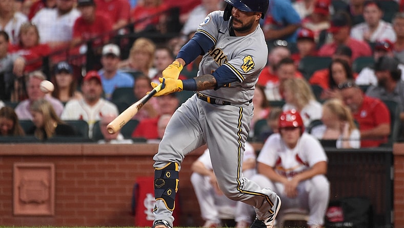 Aug 17, 2021; St. Louis, Missouri, USA; Milwaukee Brewers catcher Omar Narvaez (10) hits an RBI double against the St. Louis Cardinals during the third inning at Busch Stadium. Mandatory Credit: Joe Puetz-USA TODAY Sports