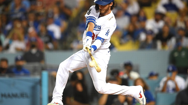 Aug 17, 2021; Los Angeles, California, USA;  Los Angeles Dodgers center fielder Cody Bellinger (35) hits a double in the third inning against the Pittsburgh Pirates at Dodger Stadium. Mandatory Credit: Jayne Kamin-Oncea-USA TODAY Sports