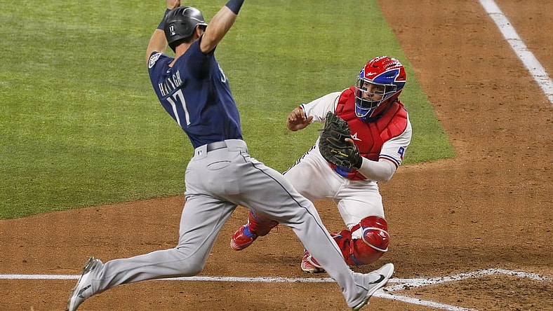 Aug 18, 2021; Arlington, Texas, USA; Texas Rangers catcher Jose Trevino (right) tags out Seattle Mariners right fielder Mitch Haniger (17) as Haniger tries to score during the sixth inning at Globe Life Field. Mandatory Credit: Raymond Carlin III-USA TODAY Sports