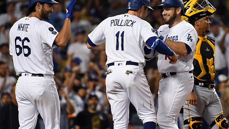 Aug 18, 2021; Los Angeles, California, USA; Los Angeles Dodgers first baseman Max Muncy (second from right) is congratulated by left fielder A.J. Pollock (11) and relief pitcher Mitch White (66) after hitting a three-run home run against the Pittsburgh Pirates during the fourth inning at Dodger Stadium. Mandatory Credit: Richard Mackson-USA TODAY Sports