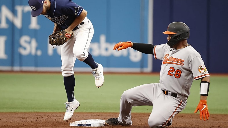 Aug 19, 2021; St. Petersburg, Florida, USA; Baltimore Orioles catcher Pedro Severino (28) doubles as Tampa Bay Rays second baseman Brandon Lowe (8) attempted to force him out at Tropicana Field. Mandatory Credit: Kim Klement-USA TODAY Sports