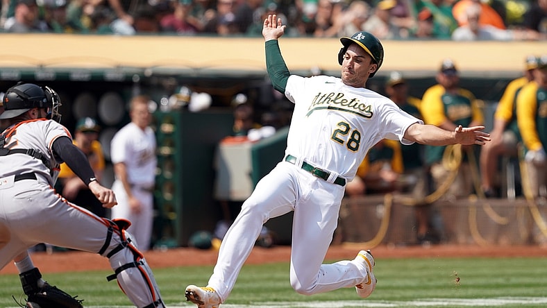 Aug 21, 2021; Oakland, California, USA; Oakland Athletics first baseman Matt Olson (28) slides into home plate to score a run as San Francisco Giants catcher Curt Casali (2) waits for a throw during the third inning at RingCentral Coliseum. Mandatory Credit: Darren Yamashita-USA TODAY Sports