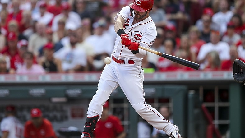 Aug 21, 2021; Cincinnati, Ohio, USA; Cincinnati Reds center fielder Tyler Naquin (12) hits a double against the Miami Marlins in the first inning at Great American Ball Park. Mandatory Credit: Katie Stratman-USA TODAY Sports