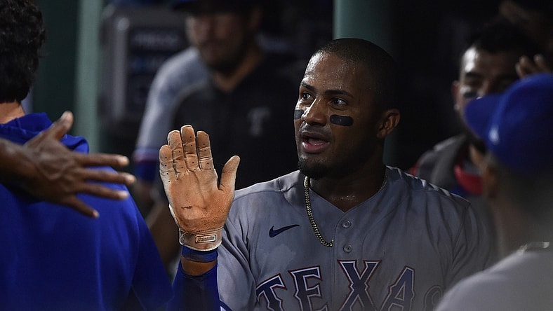 Aug 21, 2021; Boston, Massachusetts, USA;  Texas Rangers left fielder Andy Ibanez (77) is greeted in the dugout after scoring a run against the Boston Red Sox during the fourth inning at Fenway Park. Mandatory Credit: Bob DeChiara-USA TODAY Sports