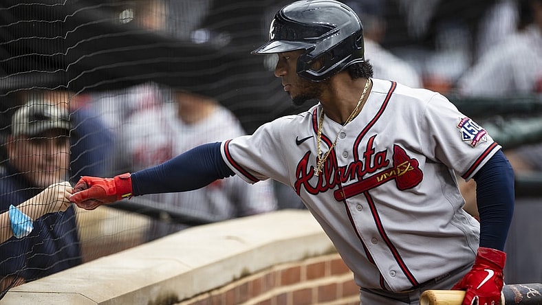 Aug 22, 2021; Baltimore, Maryland, USA; Atlanta Braves second baseman Ozzie Albies (1) first bumps a young fan during the first inning against the Baltimore Orioles at Oriole Park at Camden Yards. Mandatory Credit: Scott Taetsch-USA TODAY Sports