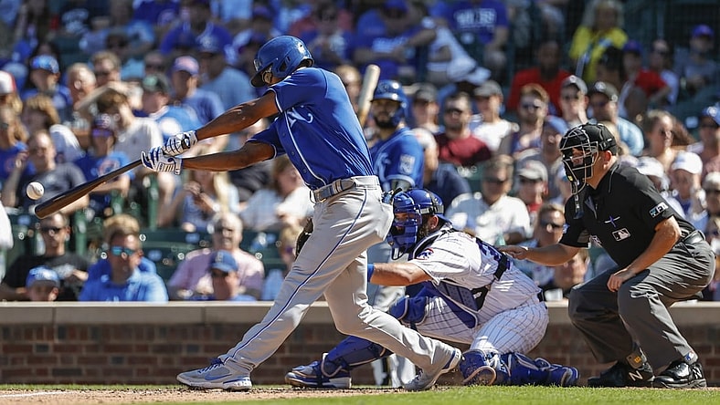 Aug 22, 2021; Chicago, Illinois, USA; Kansas City Royals center fielder Michael A. Taylor (2) hits a sacrifice fly against the the Chicago Cubs during the fifth inning at Wrigley Field. Mandatory Credit: Kamil Krzaczynski-USA TODAY Sports