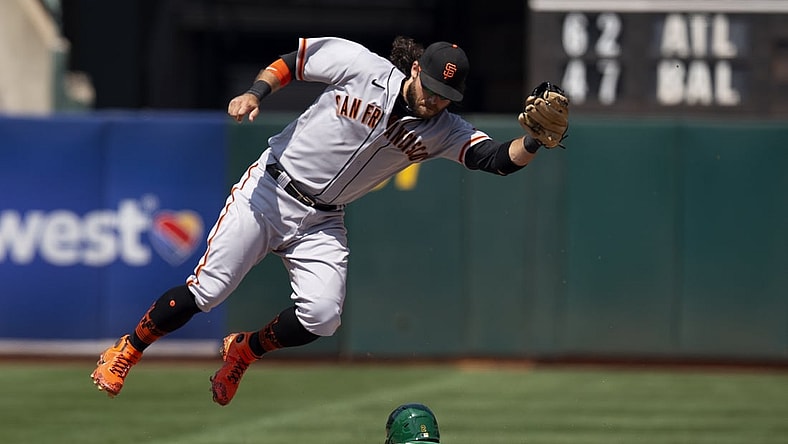 Aug 22, 2021; Oakland, California, USA; Oakland Athletics center fielder Starling Marte (2) slides safely into second with a stolen base as San Francisco Giants shortstop Brandon Crawford (35) has to leave his feet to corral the relay during the fourth inning at RingCentral Coliseum. Mandatory Credit: D. Ross Cameron-USA TODAY Sports