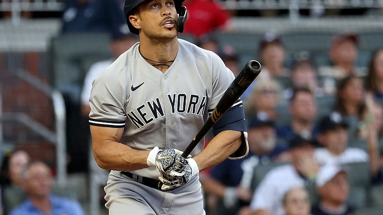 Aug 23, 2021; Atlanta, Georgia, USA; New York Yankees outfielder Giancarlo Stanton (27) hits a solo home run against the Atlanta Braves during the second inning at Truist Park. Mandatory Credit: Jason Getz-USA TODAY Sports