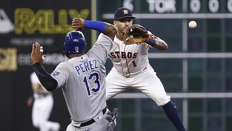 Aug 23, 2021; Houston, Texas, USA; Kansas City Royals catcher Salvador Perez (13) is out at second base as Houston Astros shortstop Carlos Correa (1) fields a throw during the first inning at Minute Maid Park. Mandatory Credit: Troy Taormina-USA TODAY Sports
