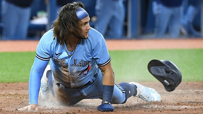 Aug 23, 2021; Toronto, Ontario, CAN;  Toronto Blue Jays shortstop Bo Bichette (11) slides home to score against the Chicago White Sox in the sixth inning at Rogers Centre. Mandatory Credit: Dan Hamilton-USA TODAY Sports