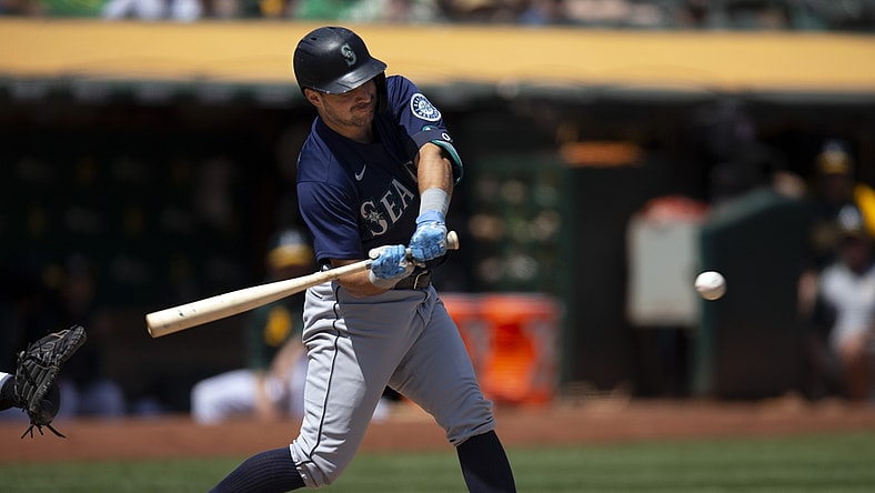 Aug 24, 2021; Oakland, California, USA; Seattle Mariners designated hitter Luis Torrens (22) connects for a two-RBI single against the Oakland Athletics during the third inning at RingCentral Coliseum. Mandatory Credit: D. Ross Cameron-USA TODAY Sports