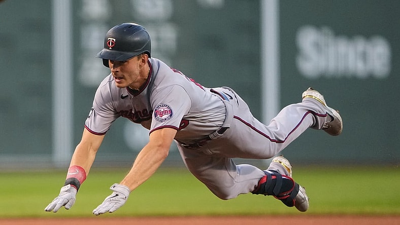 Aug 24, 2021; Boston, Massachusetts, USA;  Minnesota Twins right fielder Max Kepler (26) dives into third base with a triple during the first inning against the Boston Red Sox at Fenway Park. Mandatory Credit: Gregory Fisher-USA TODAY Sports