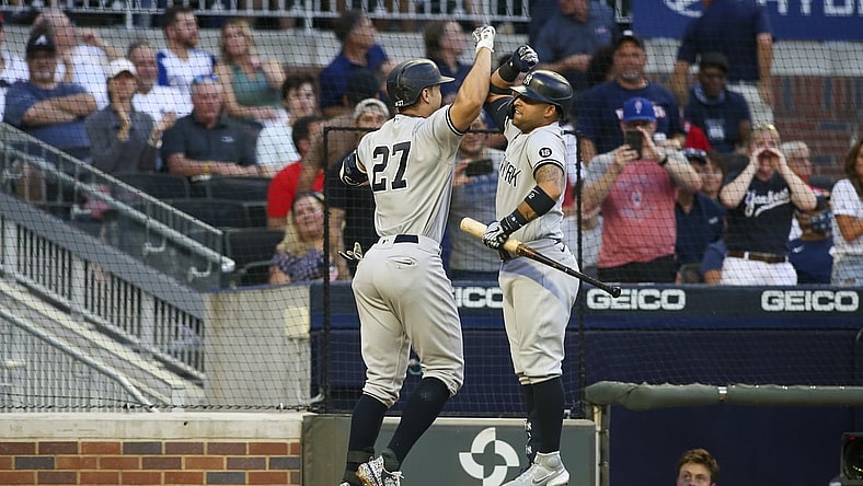 Aug 24, 2021; Atlanta, Georgia, USA; New York Yankees right fielder Giancarlo Stanton (27) celebrates with third baseman Rougned Odor (12) after a home run against the Atlanta Braves in the second inning at Truist Park. Mandatory Credit: Brett Davis-USA TODAY Sports