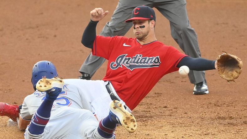 Aug 24, 2021; Cleveland, Ohio, USA; Cleveland Indians second baseman Ernie Clement (28) reaches for the ball as Texas Rangers second baseman Nick Solak (15) steals second base in the second inning at Progressive Field. Mandatory Credit: David Richard-USA TODAY Sports