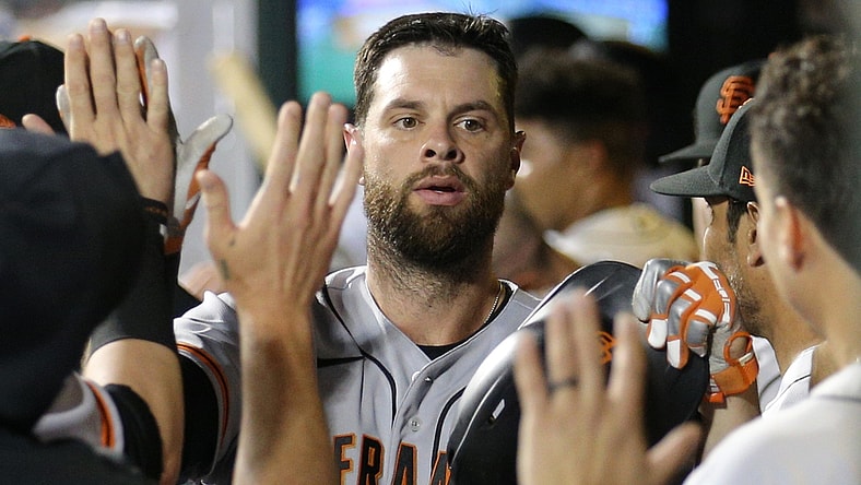 Aug 24, 2021; New York City, New York, USA; San Francisco Giants first baseman Brandon Belt (9) celebrates his solo home run against the New York Mets in the dugout with teammates during the fourth inning at Citi Field. Mandatory Credit: Brad Penner-USA TODAY Sports