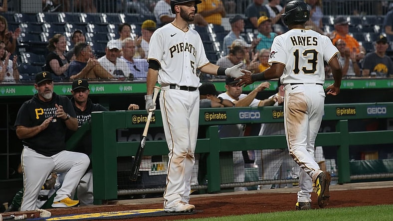 Aug 24, 2021; Pittsburgh, Pennsylvania, USA; Pittsburgh Pirates catcher Jacob Stallings (58) congratulates third baseman Ke'Bryan Hayes (13) after Hayes scored a run against the Arizona Diamondbacks during the third inning at PNC Park. Mandatory Credit: Charles LeClaire-USA TODAY Sports