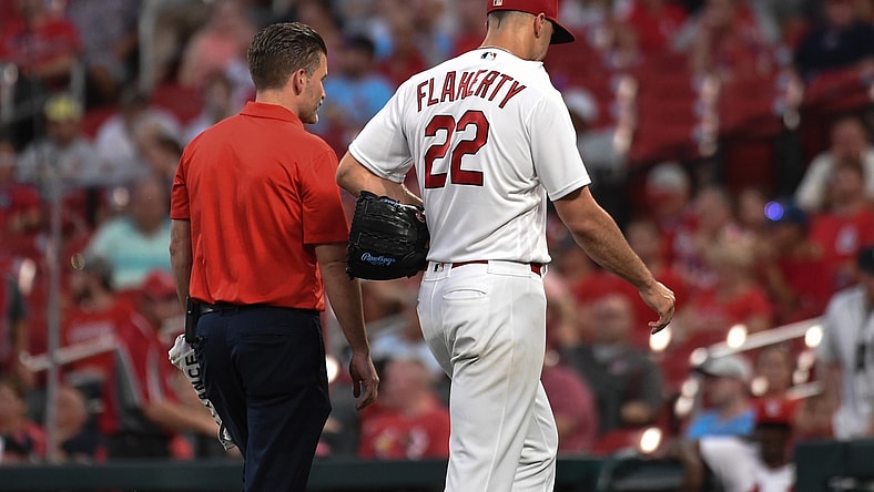 Aug 24, 2021; St. Louis, Missouri, USA; St. Louis Cardinals starting pitcher Jack Flaherty (22) leaves the field with a trainer after being pulled from the game against the Detroit Tigers during the third inning at Busch Stadium. Mandatory Credit: Joe Puetz-USA TODAY Sports