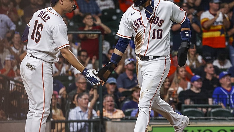 Aug 24, 2021; Houston, Texas, USA; Houston Astros first baseman Yuli Gurriel (10) celebrates with third baseman Aledmys Diaz (16) after scoring a run against the Kansas City Royals during the third inning at Minute Maid Park. Mandatory Credit: Troy Taormina-USA TODAY Sports