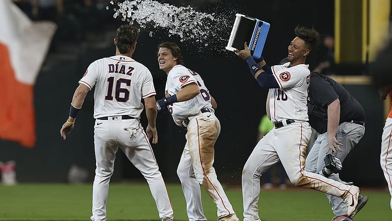 Aug 25, 2021; Houston, Texas, USA; Houston Astros left fielder Aledmys Diaz (16) and  first baseman Yuli Gurriel (10) celebrate center fielder Jake Meyers (6) game winning RBI single against the Kansas City Royals in the tenth inning at Minute Maid Park. Mandatory Credit: Thomas Shea-USA TODAY Sports