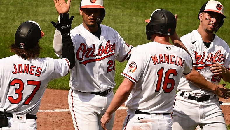 Aug 26, 2021; Baltimore, Maryland, USA; Baltimore Orioles catcher Pedro Severino (28) celebrates with second baseman Jahmai Jones (37), right fielder Trey Mancini (16) and  shortstop Ramon Urias (29) after hitting a fifth inning grand slam against the Los Angeles Angels  at Oriole Park at Camden Yards. Mandatory Credit: Tommy Gilligan-USA TODAY Sports