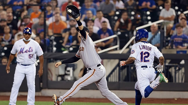 Aug 26, 2021; New York City, New York, USA; New York Mets shortstop Francisco Lindor (12) beats a throw caught by San Francisco Giants second baseman Wilmer Flores (41) for a single during the third inning at Citi Field. Mandatory Credit: Vincent Carchietta-USA TODAY Sports