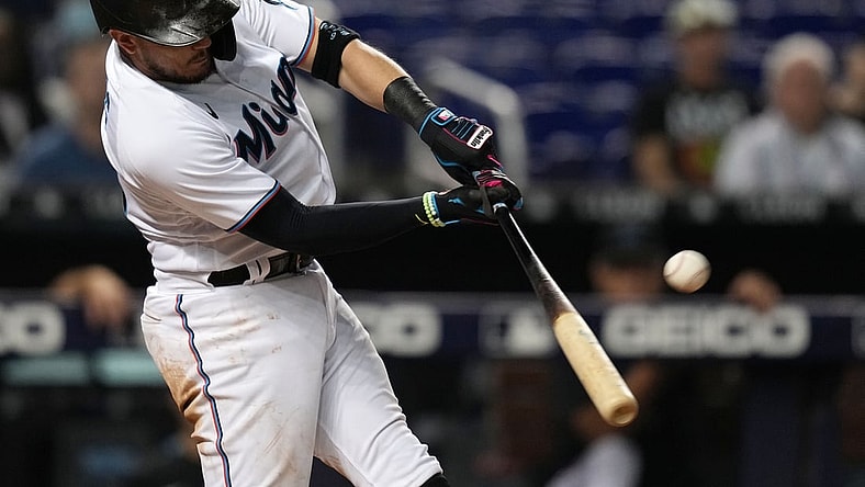 Aug 26, 2021; Miami, Florida, USA; Miami Marlins shortstop Miguel Rojas (19) connects for a two-run homerun in the 2nd inning against the Washington Nationals at loanDepot park. Mandatory Credit: Jasen Vinlove-USA TODAY Sports