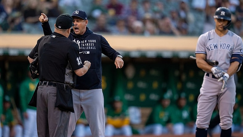 Aug 26, 2021; Oakland, California, USA;  New York Yankees manager Aaron Boone (17) argues with umpire Todd Tichenor (13) after being ejected from the game against the Oakland Athletics during the second inning at RingCentral Coliseum. Mandatory Credit: Neville E. Guard-USA TODAY Sports