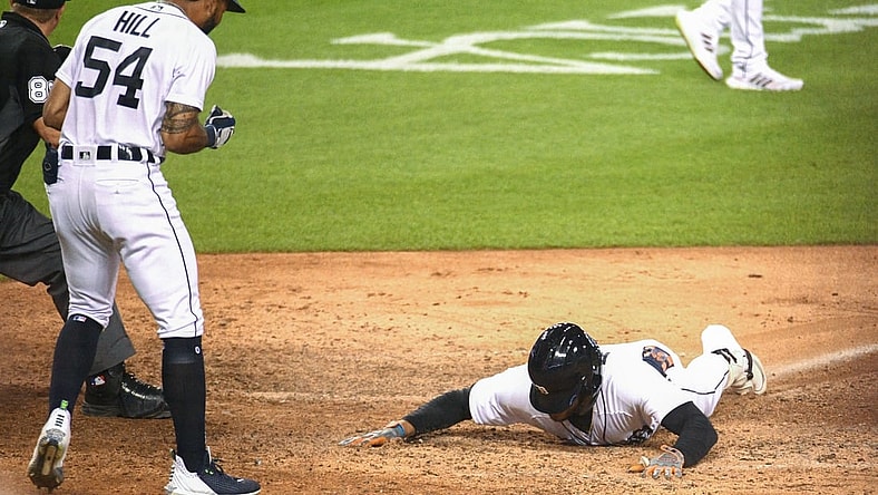Aug 27, 2021; Detroit, Michigan, USA; Detroit Tigers center fielder Victor Reyes (22) slides into home after a in the park home run during the eighth inning against the Toronto Blue Jays at Comerica Park. Mandatory Credit: Tim Fuller-USA TODAY Sports