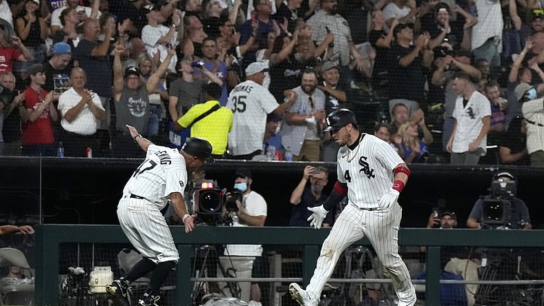 Aug 27, 2021; Chicago, Illinois, USA; Chicago White Sox catcher Yasmani Grandal (24) celebrates with third base coach Joe McEwing (47) after hitting a three-run home run against the Chicago Cubs during the third inning at Guaranteed Rate Field. Mandatory Credit: Mike Dinovo-USA TODAY Sports