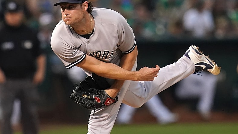 Aug 27, 2021; Oakland, California, USA; New York Yankees pitcher Gerrit Cole (45) follows through on a pitch against the Oakland Athletics in the third inning at RingCentral Coliseum. Mandatory Credit: Cary Edmondson-USA TODAY Sports