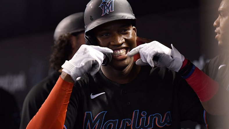 Aug 28, 2021; Miami, Florida, USA; Miami Marlins outfielder Jesus Sanchez (76) celebrates with teammates after hitting a three run home run against the Cincinnati Reds during the first inning at loanDepot Park. Mandatory Credit: Jim Rassol-USA TODAY Sports