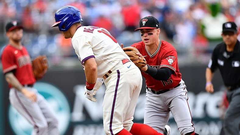 Aug 29, 2021; Philadelphia, Pennsylvania, USA; Arizona Diamondbacks second baseman Andrew Young (15) tags out Philadelphia Phillies first baseman J.T. Realmuto (10) in a rundown in the third inning at Citizens Bank Park. Mandatory Credit: Kyle Ross-USA TODAY Sports