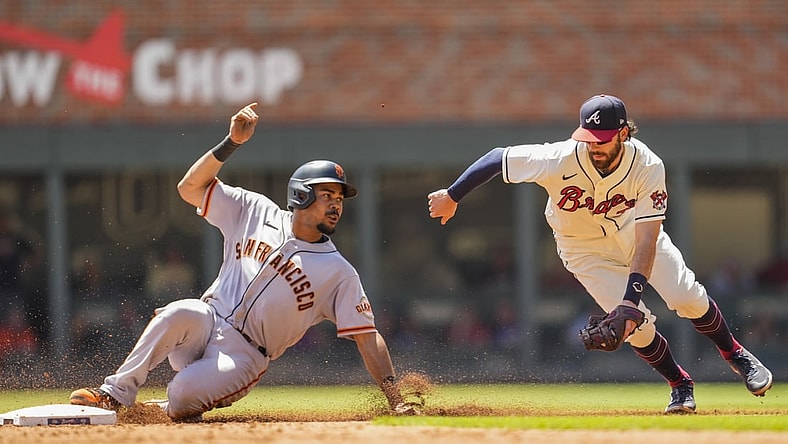 Aug 29, 2021; Cumberland, Georgia, USA; San Francisco Giants right fielder LaMonte Wade Jr. (31) steals second base ahead of a tag by Atlanta Braves shortstop Dansby Swanson (7) during the third inning at Truist Park. Mandatory Credit: Dale Zanine-USA TODAY Sports