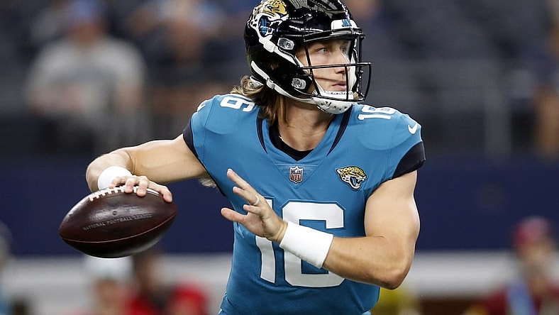 Aug 29, 2021; Arlington, Texas, USA; Jacksonville Jaguars quarterback Trevor Lawrence (16) rolls out to throw a pass in the first quarter against the Dallas Cowboys at AT&T Stadium. Mandatory Credit: Tim Heitman-USA TODAY Sports