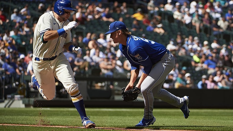 Aug 29, 2021; Seattle, Washington, USA;  Kansas City Royals starting pitcher Brady Singer (51) tags Seattle Mariners catcher Cal Raleigh (29) for an out during the fourth inning at T-Mobile Park. Mandatory Credit: Troy Wayrynen-USA TODAY Sports