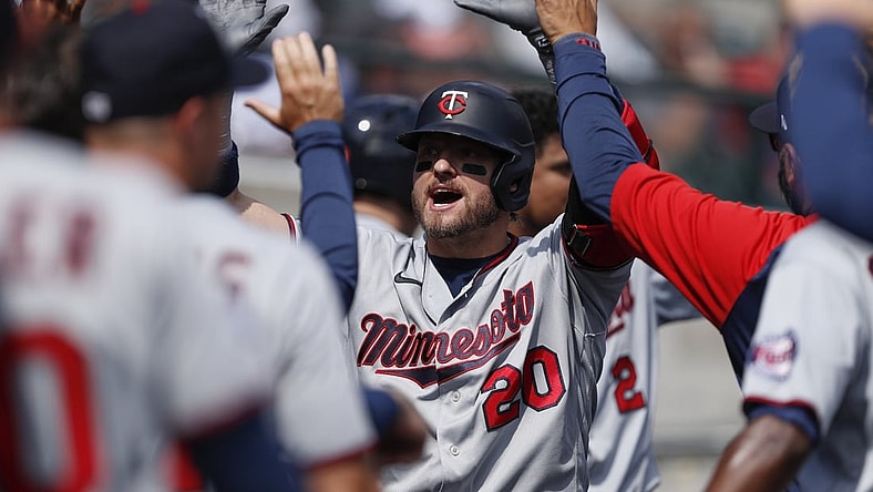 Aug 30, 2021; Detroit, Michigan, USA; Minnesota Twins designated hitter Josh Donaldson (20) is congratulated in the dugout after hitting a two-run home run during the fourth inning against the Detroit Tigers at Comerica Park. Mandatory Credit: Raj Mehta-USA TODAY Sports