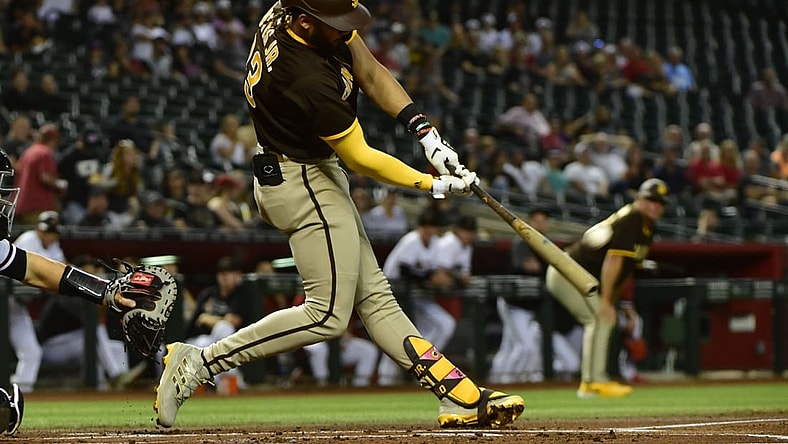 Aug 30, 2021; Phoenix, Arizona, USA;  San Diego Padres shortstop Fernando Tatis Jr. (23) hits a two run home run in the first inning against the Arizona Diamondbacks at Chase Field. Mandatory Credit: Matt Kartozian-USA TODAY Sports