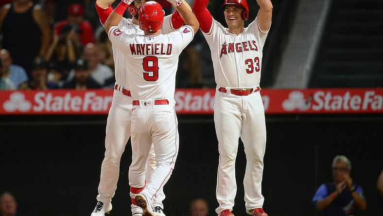 Aug 30, 2021; Anaheim, California, USA; Los Angeles Angels shortstop Jack Mayfield (9) is greeted by first baseman Jared Walsh (20) and catcher Max Stassi (33) after hitting a grand slam home run against the New York Yankees during the fourth inning at Angel Stadium. Mandatory Credit: Gary A. Vasquez-USA TODAY Sports