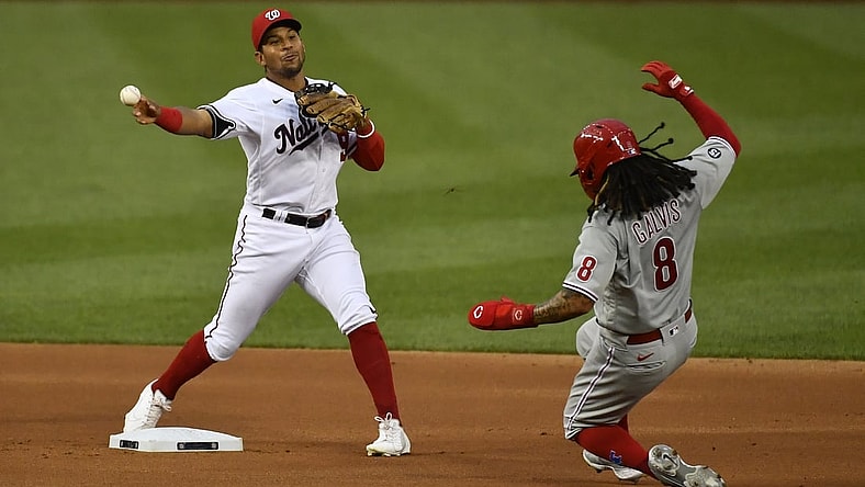 Aug 31, 2021; Washington, District of Columbia, USA; Washington Nationals second baseman Adrian Sanchez (9) turns a double play over Philadelphia Phillies shortstop Freddy Galvis (8) at Nationals Park. Mandatory Credit: Brad Mills-USA TODAY Sports