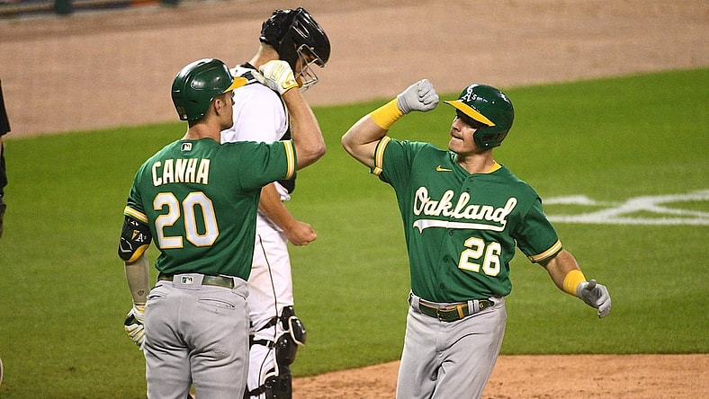 Aug 31, 2021; Detroit, Michigan, USA; Oakland Athletics third baseman Matt Chapman (26) celebrates with left fielder Mark Canha (20) after hitting a home run against the Detroit Tigers during the ninth inning at Comerica Park. Mandatory Credit: Tim Fuller-USA TODAY Sports