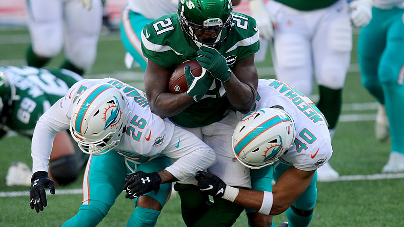 Nov 29, 2020; East Rutherford, New Jersey, USA; New York Jets running back Frank Gore (21) runs against Miami Dolphins cornerback Xavien Howard (25) and defensive back Nik Needham (40) during the first half at MetLife Stadium. Mandatory Credit: Kevin Wexler-USA TODAY Sports