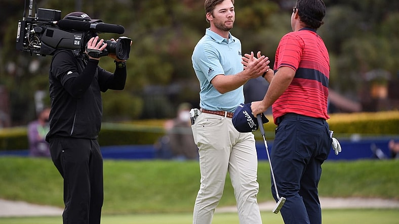 Jan 31, 2021; San Diego, California, USA; Sam Burns (C) and Patrick Reed (R) shake hands following their final round of the Farmers Insurance Open golf tournament at Torrey Pines Municipal Golf Course - South Course. Mandatory Credit: Orlando Ramirez-USA TODAY Sports