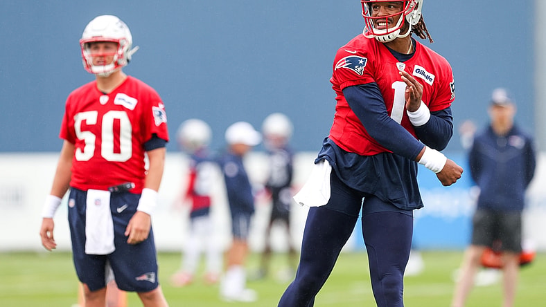 Jul 28, 2021; Foxborough, MA, United States; New England Patriots quarterback Mac Jones (50) watches New England Patriots quarterback Cam Newton (1) during training camp at Gillette Stadium. Mandatory Credit: Paul Rutherford-USA TODAY Sports