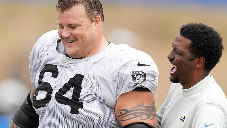 Aug 18, 2021; Thousand Oaks, CA, USA; Las Vegas Raiders  guard Richie Incognito (64) interacts with Los Angeles Rams vice president of communications Artis Twyman during a joint practice. Mandatory Credit: Kirby Lee-USA TODAY Sports