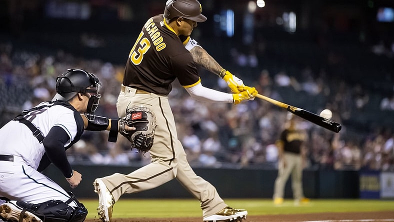 Aug 31, 2021; Phoenix, Arizona, USA; San Diego Padres third baseman Manny Machado hits a two run home run in the fifth inning against the Arizona Diamondbacks at Chase Field. Mandatory Credit: Mark J. Rebilas-USA TODAY Sports