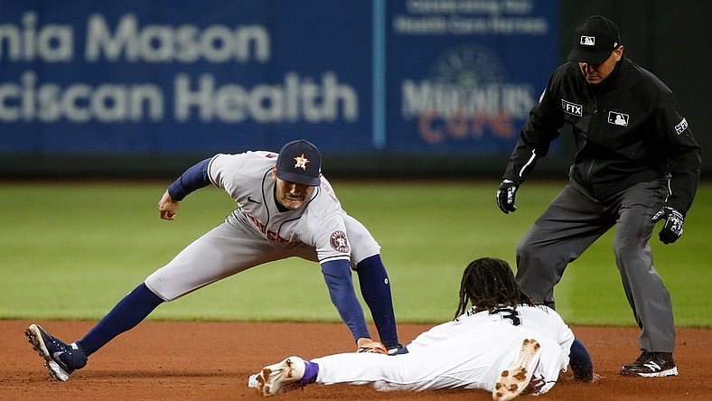 Aug 31, 2021; Seattle, Washington, USA; Houston Astros shortstop Carlos Correa (1) tags out Seattle Mariners shortstop J.P. Crawford (3) on a stolen base attempt during the third inning at T-Mobile Park. Mandatory Credit: Joe Nicholson-USA TODAY Sports