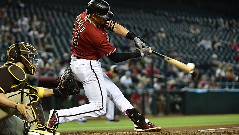 Sep 1, 2021; Phoenix, Arizona, USA; Arizona Diamondbacks shortstop Nick Ahmed (13) hits an RBI single in the third inning against the San Diego Padres at Chase Field. Mandatory Credit: Matt Kartozian-USA TODAY Sports