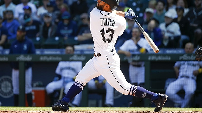 Sep 1, 2021; Seattle, Washington, USA; Seattle Mariners second baseman Abraham Toro (13) hits an RBI-sacrifice fly against the Houston Astros during the sixth inning at T-Mobile Park. Mandatory Credit: Joe Nicholson-USA TODAY Sports
