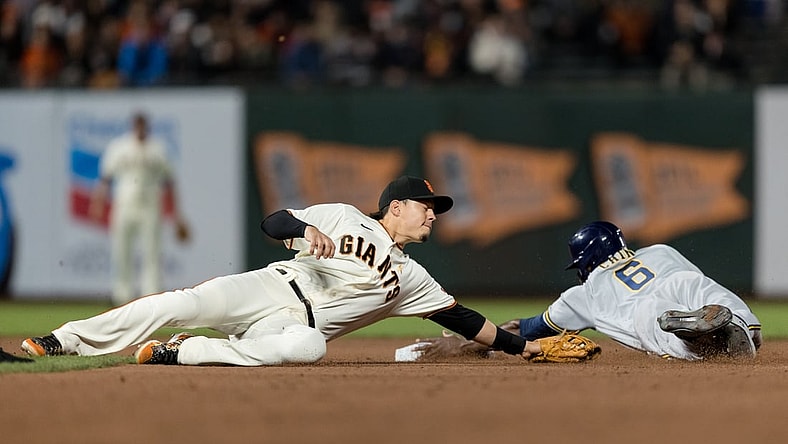 Sep 1, 2021; San Francisco, California, USA; Milwaukee Brewers center fielder Lorenzo Cain (6) dives safely into second base after San Francisco Giants third baseman Wilmer Flores (41) is late with the tag in the fifth inning at Oracle Park. Mandatory Credit: John Hefti-USA TODAY Sports